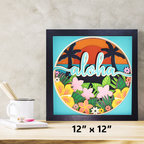 Framed artwork with 'aloha' text and tropical design on a wooden surface.