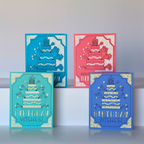 Four colorful birthday cards with cake designs on a white surface.