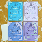 Four birthday cards with cake and candle designs on a patterned background