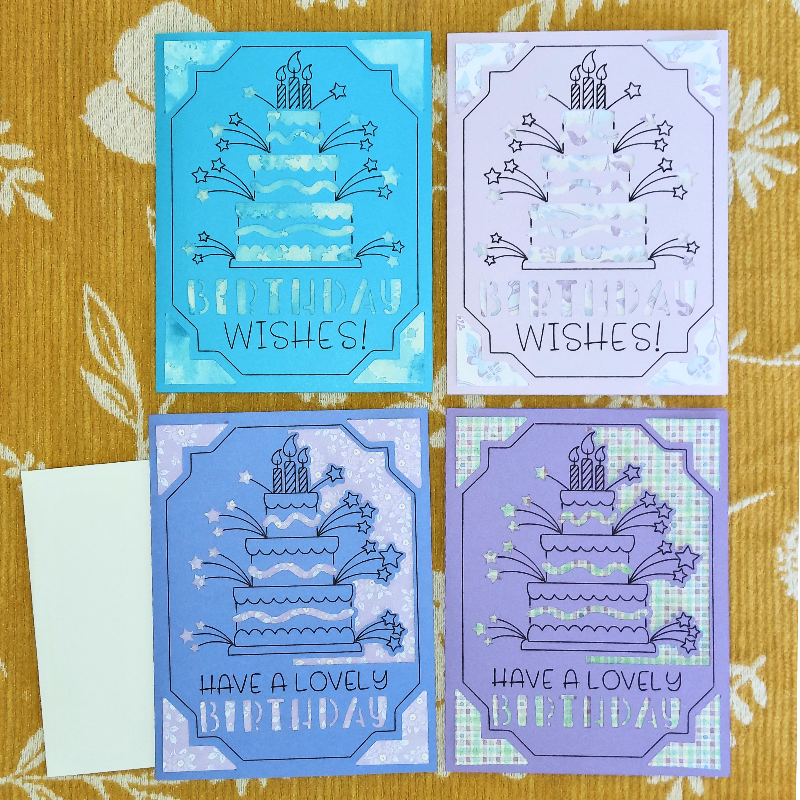 Four birthday cards with cake and candle designs on a patterned background