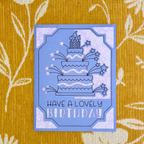 Blue birthday card with cake illustration on a yellow patterned background