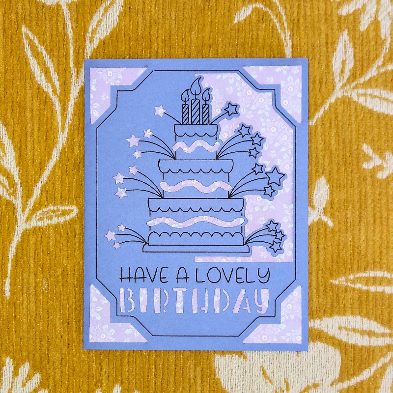 Blue birthday card with cake illustration on a yellow floral background