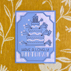 Blue birthday card with cake illustration on a yellow floral background