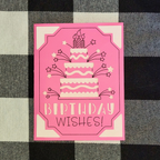 Pink birthday card with cake illustration and 'Birthday Wishes!' text on a checkered background
