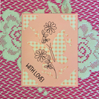 Card with butterfly and floral design on a patterned background