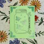 Green card with butterfly design and 'Believe in Magic' text on a floral background