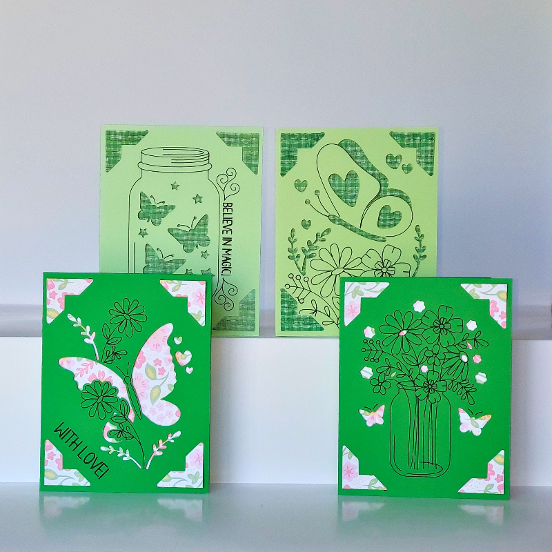 Four green greeting cards with floral and nature-themed designs on a white background