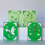 Four green greeting cards with floral and nature-themed designs on a white background