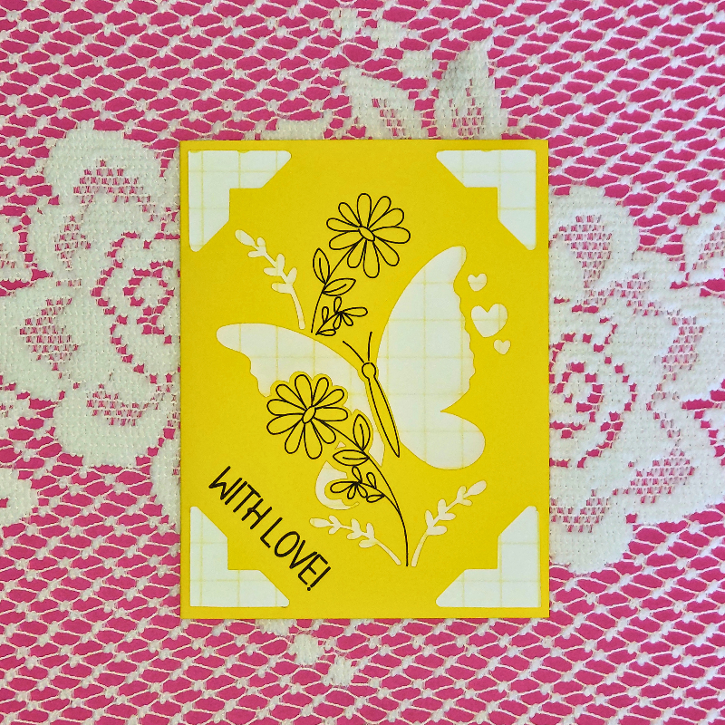 Yellow card with butterfly and floral design on a pink lace background