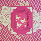 Pink card with butterfly design and 'Believe in Magic' text on a pink and white patterned background