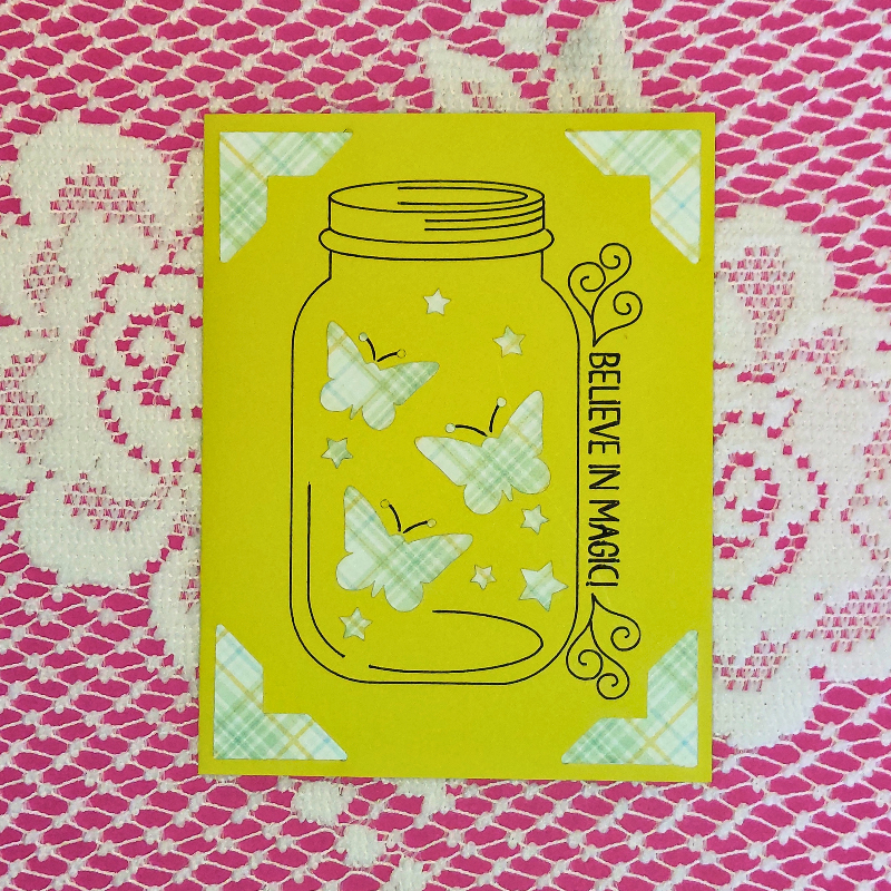 Yellow card with butterfly design and 'Believe in Magic' text on a pink and white patterned background