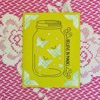 Yellow card with butterfly design and 'Believe in Magic' text on a pink and white patterned background