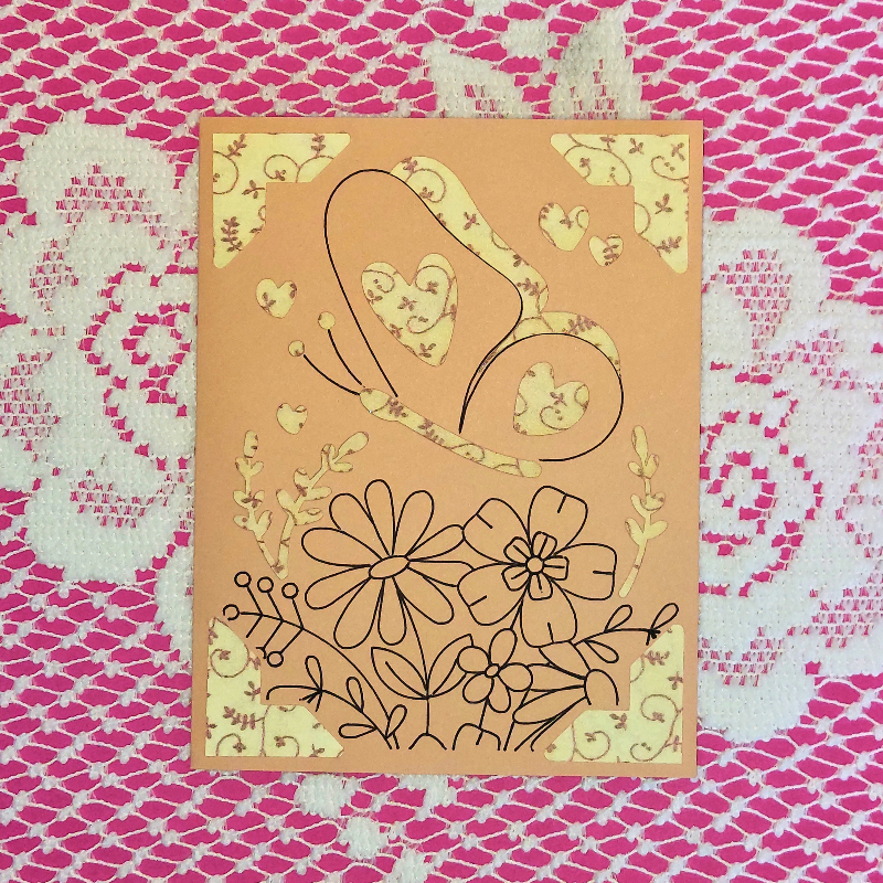 Card with floral and heart designs on a pink and white patterned background