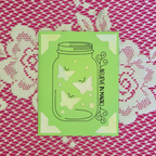 Green card with butterfly design and 'Believe in Magic' text on a pink and white patterned background