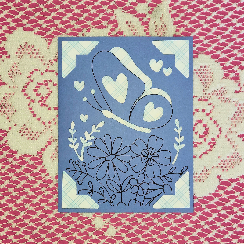 Decorative card with heart and floral design on a patterned background