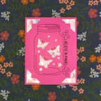 Pink card with butterfly design on a floral fabric background
