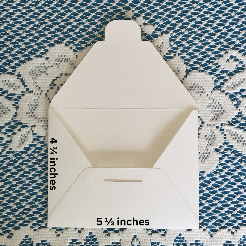 White envelope with measurements on a textured blue and white background
