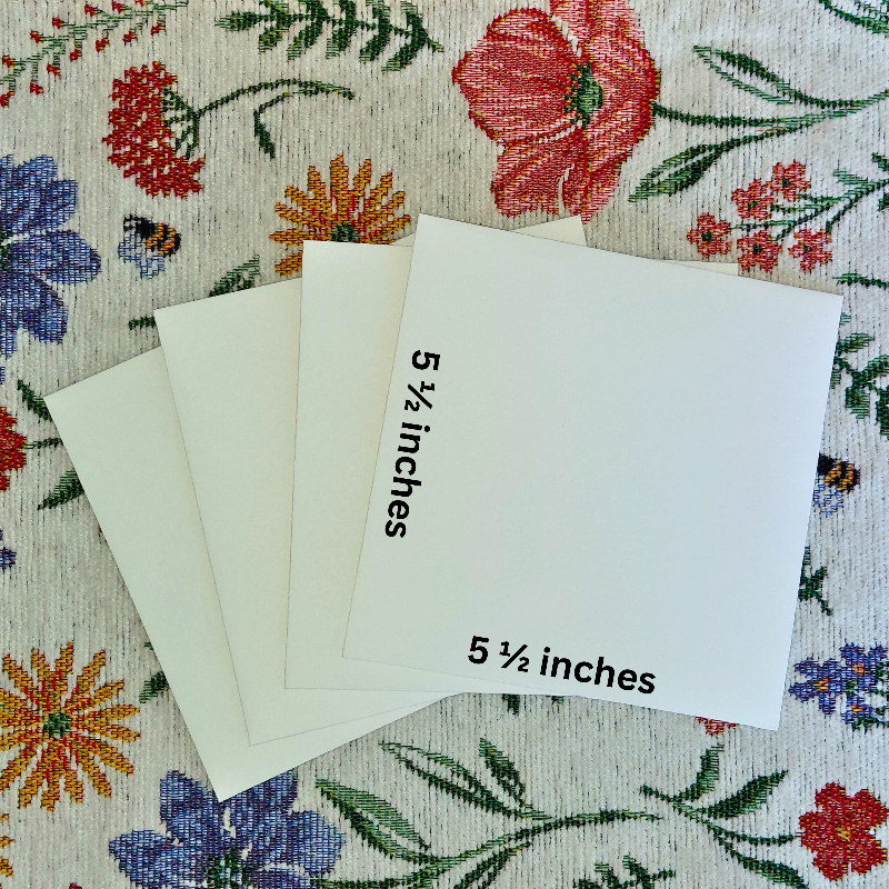 Four pieces of paper with '5 1/2 inches' text on a floral fabric background