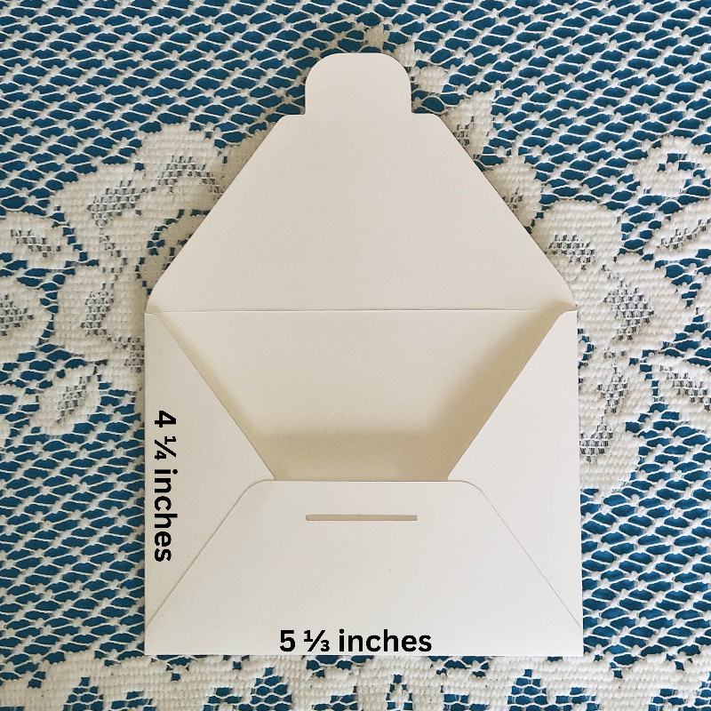 Open white envelope with measurements on a textured blue and white background