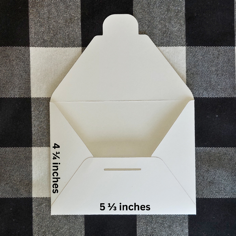 White envelope with dimensions labeled on a black and white checkered background