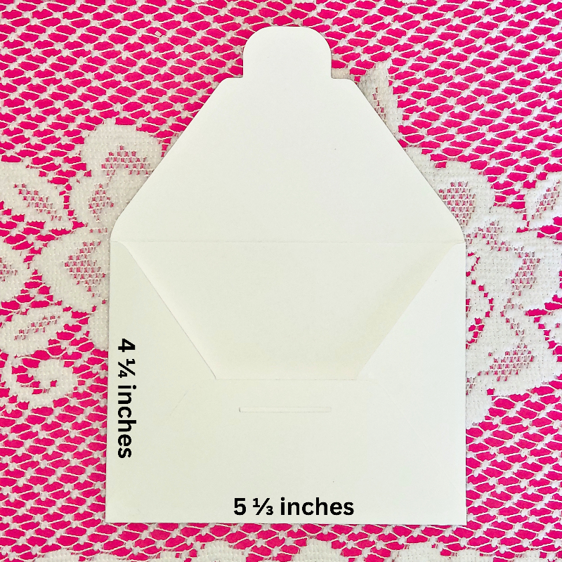 White envelope with measurements on a pink and white patterned background