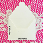 White envelope with measurements on a pink and white patterned background