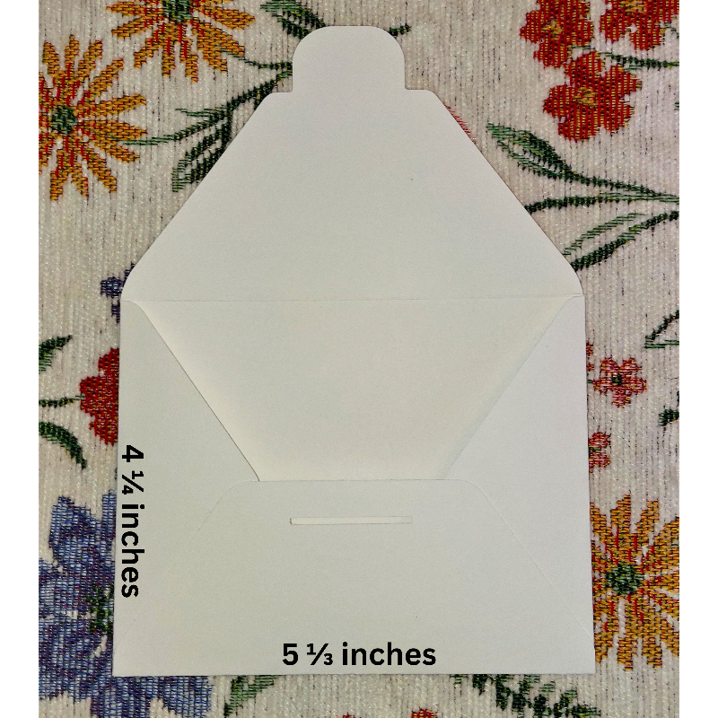 White envelope with measurements on a floral-patterned fabric background