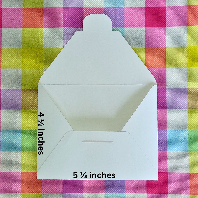 White envelope with measurements on a colorful checkered background