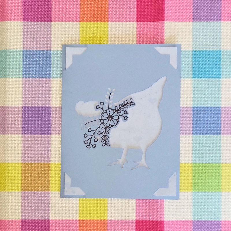 Card with a chicken and floral design on a pastel checkered background