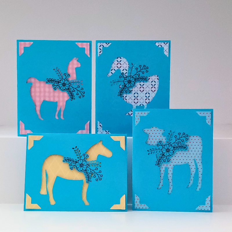 Four blue greeting cards with animal illustrations on a white background
