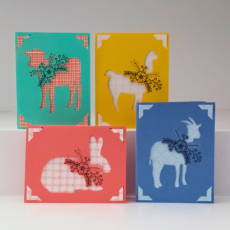 Four colorful greeting cards with animal illustrations on a white background