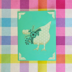 Card with a chicken silhouette and floral design on a colorful checkered background
