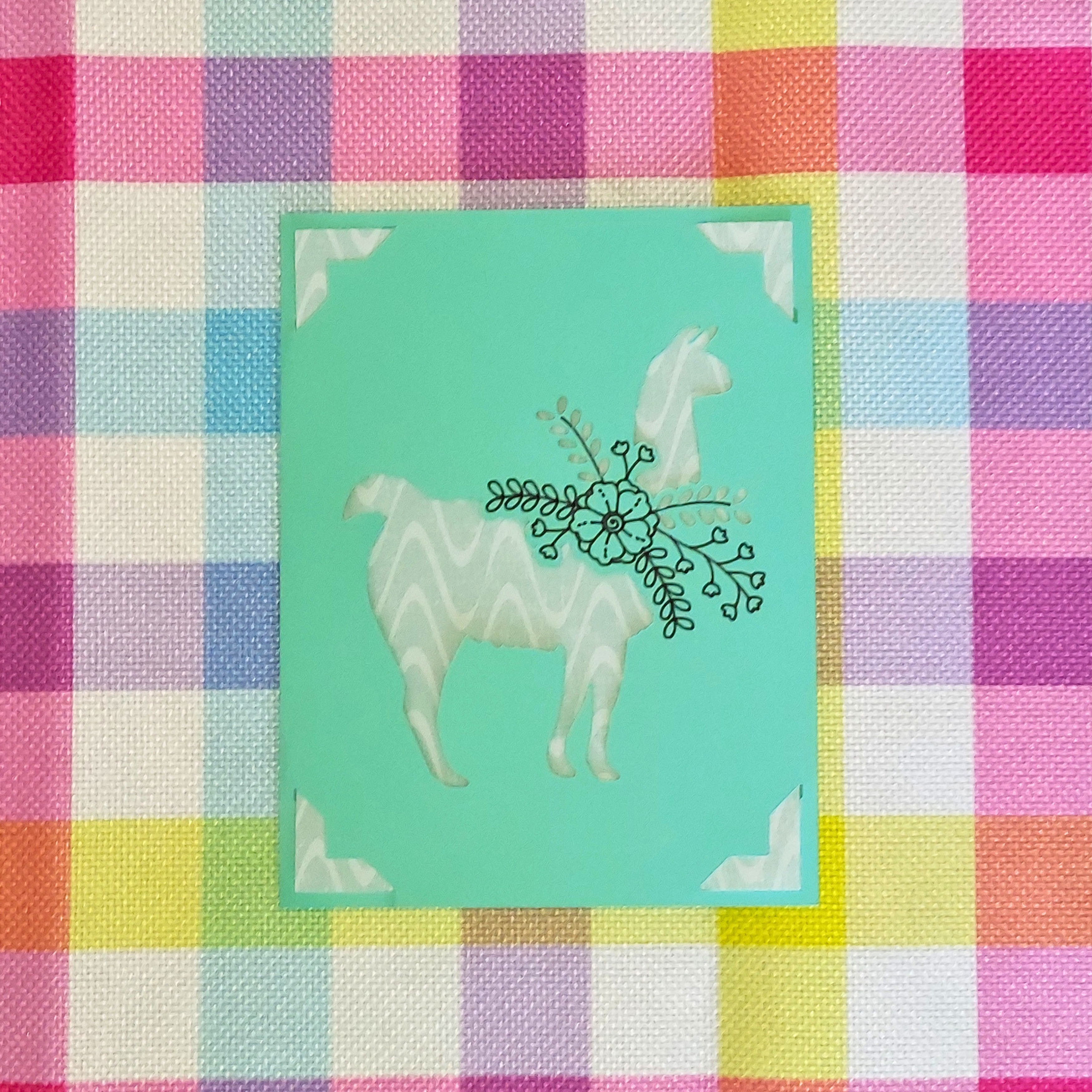 Card with a geometric horse design on a colorful checkered background
