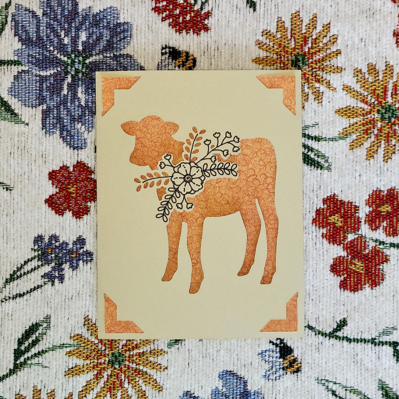 Card with a cow illustration on a floral background
