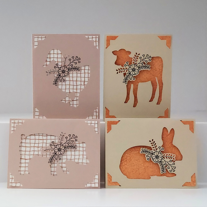 Four greeting cards with animal illustrations on a white background