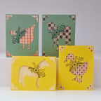 Four greeting cards with animal illustrations on a white background