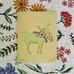 Card with llama design on a floral patterned background