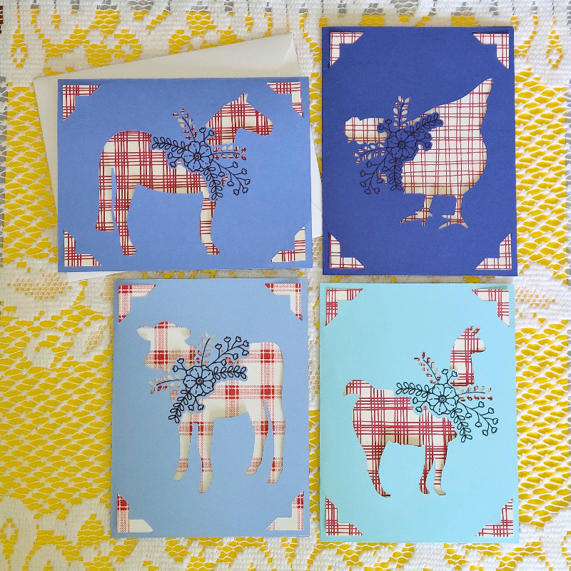 Set of four greeting cards with animal silhouettes on a decorative background