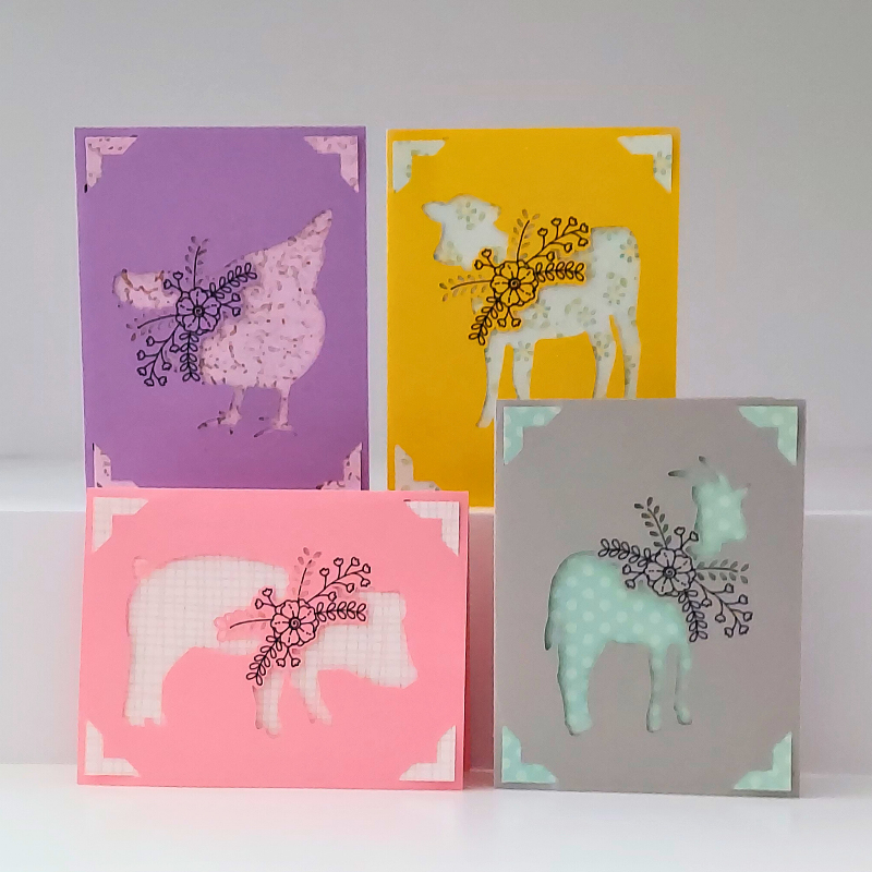 Four greeting cards with animal illustrations on a white background