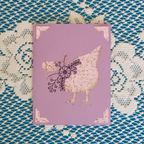 Purple card with a chicken design on a textured blue and white background