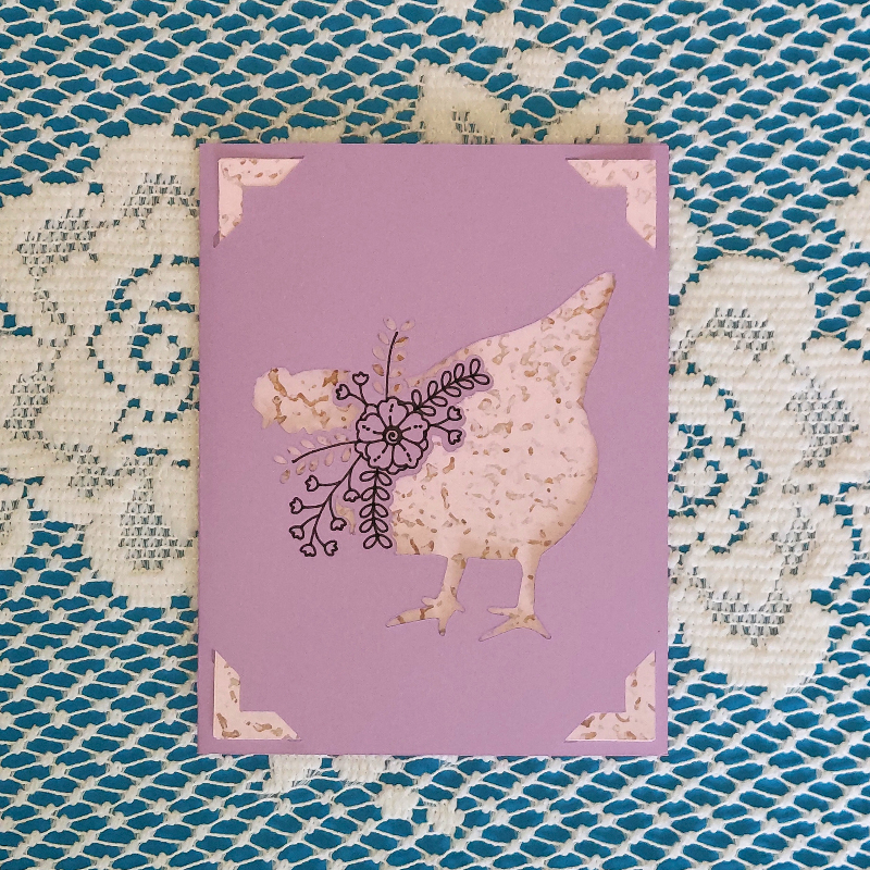 Purple card with a chicken design on a textured blue and white background