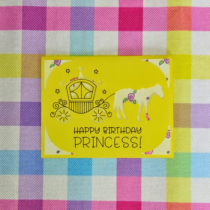 Yellow birthday card with horse and carriage illustration on a checkered fabric background