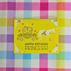 Yellow birthday card with horse and carriage illustration on a checkered fabric background