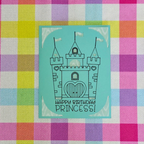 Card with castle design and 'Happy Birthday Princess!' text on a colorful checkered background