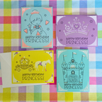 Four colorful birthday cards for a princess on a checkered fabric background