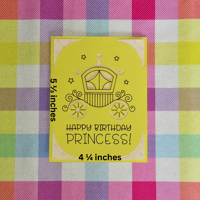Yellow birthday card with princess carriage design on a checkered fabric background