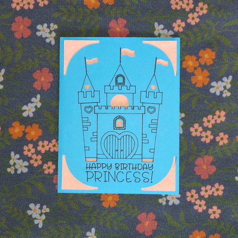 Card with castle design and 'Happy Birthday Princess!' text on a floral fabric background