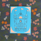 Card with castle design and 'Happy Birthday Princess!' text on a floral fabric background