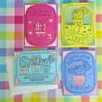 Four colorful greeting cards with cactus designs on a checkered fabric background.
