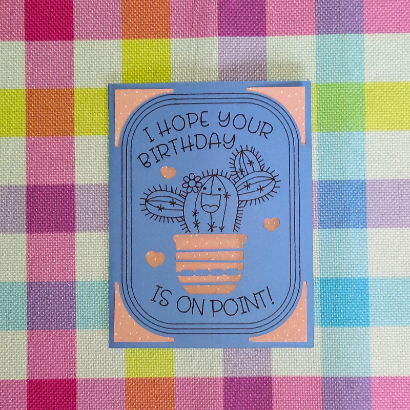 Birthday card with cactus illustration on a colorful checkered background